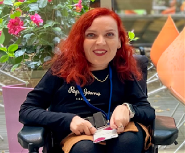 White woman with red hair smiling