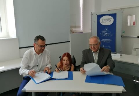 3 people, including our staff member Laura, signing the declaration