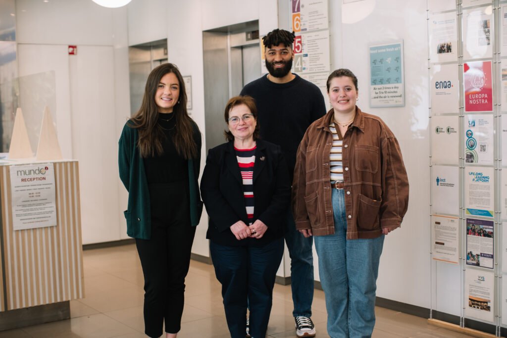 Photo of a 3 women and one man smiling at ENIL's office.