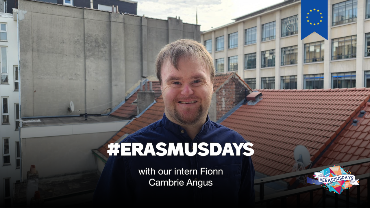 Fionn is smiling, standing on a balcony, in Brussels. Text says "Erasmus Days with our new intern Fionn Cambrie Angus". EU logo appearing on the image.