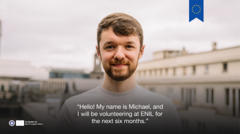 Photo of a blond man smiling on a rooftop of Brussels. Text says "Hello! My name is Michael, and I will be volunteering at ENIL for the next six months." ENIL logo and co-funded by the European Union