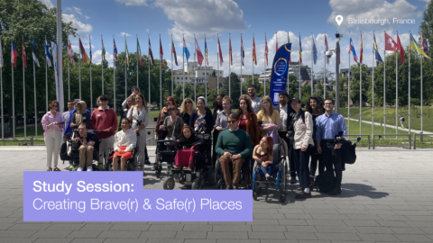 Study session: creating braver and safer places. Photo of a groupof people posing in front of flags from many countries.