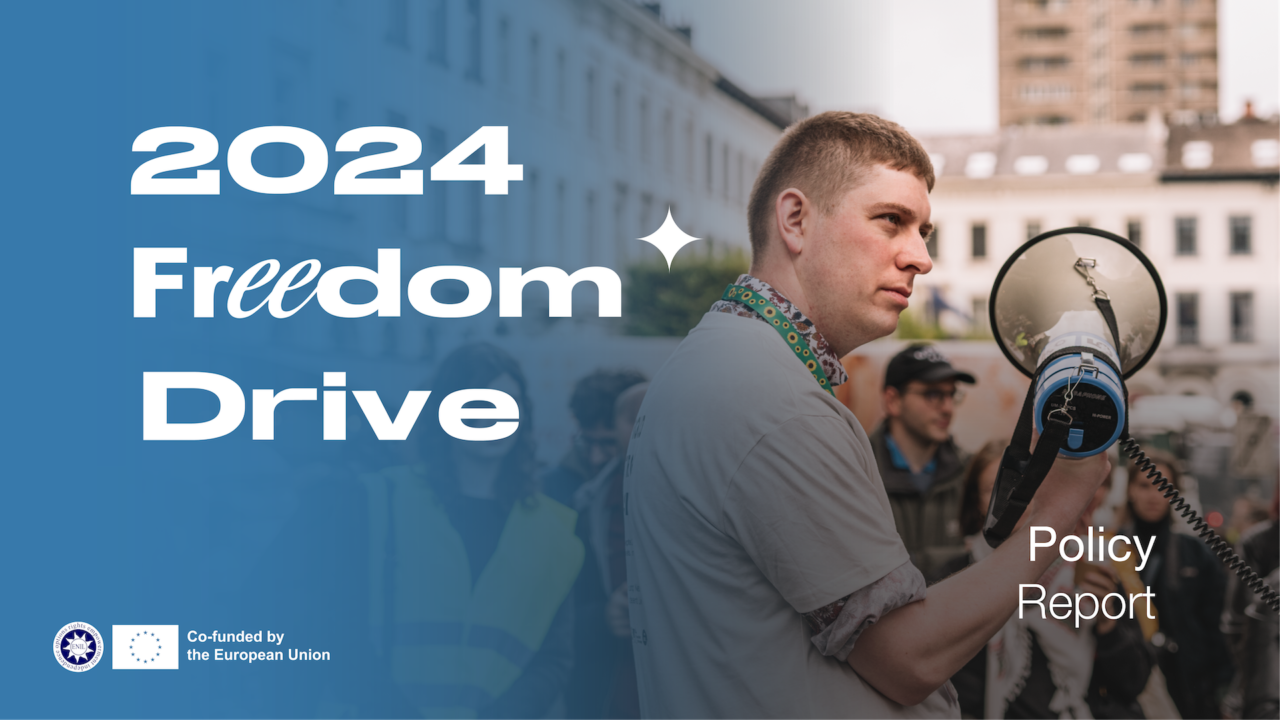 Freedom Drive 2024. Policy Report. Person holding a megaphone