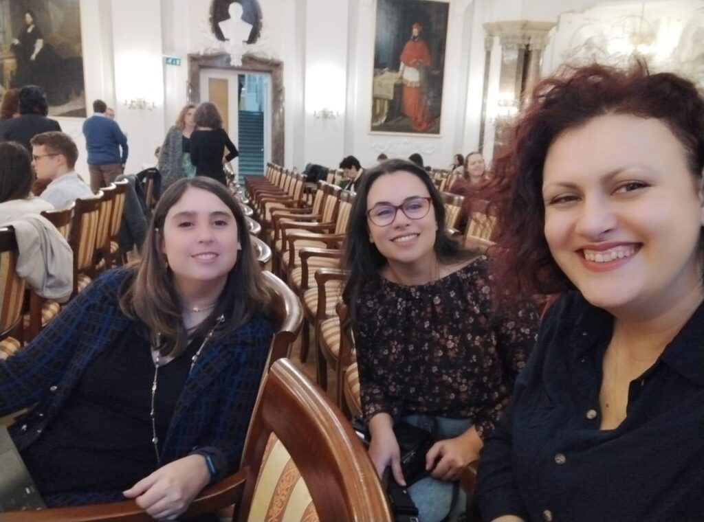 Photo of 3 women smiling, taking a photo during the event. One of them is Adela, our colleague who represented ENIL in Budapest.