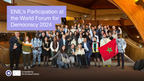 Large group of young people posing for a photo. Text says "ENIL Participation at the World Forum for Democracy 2024"