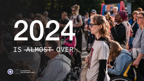 2024 is over. Photo of people watching something. It looks like they're watching the text.