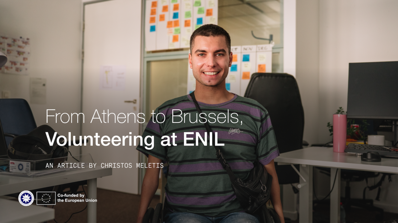 From Athens to Brussels, volunteering at ENIL. Man in a wheelchair smiliing in the office