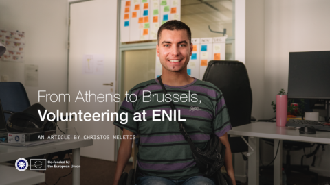 From Athens to Brussels, volunteering at ENIL. Man in a wheelchair smiliing in the office