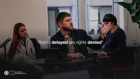 "Rights delayed are rights denied". Photo of a man speaking at an event.