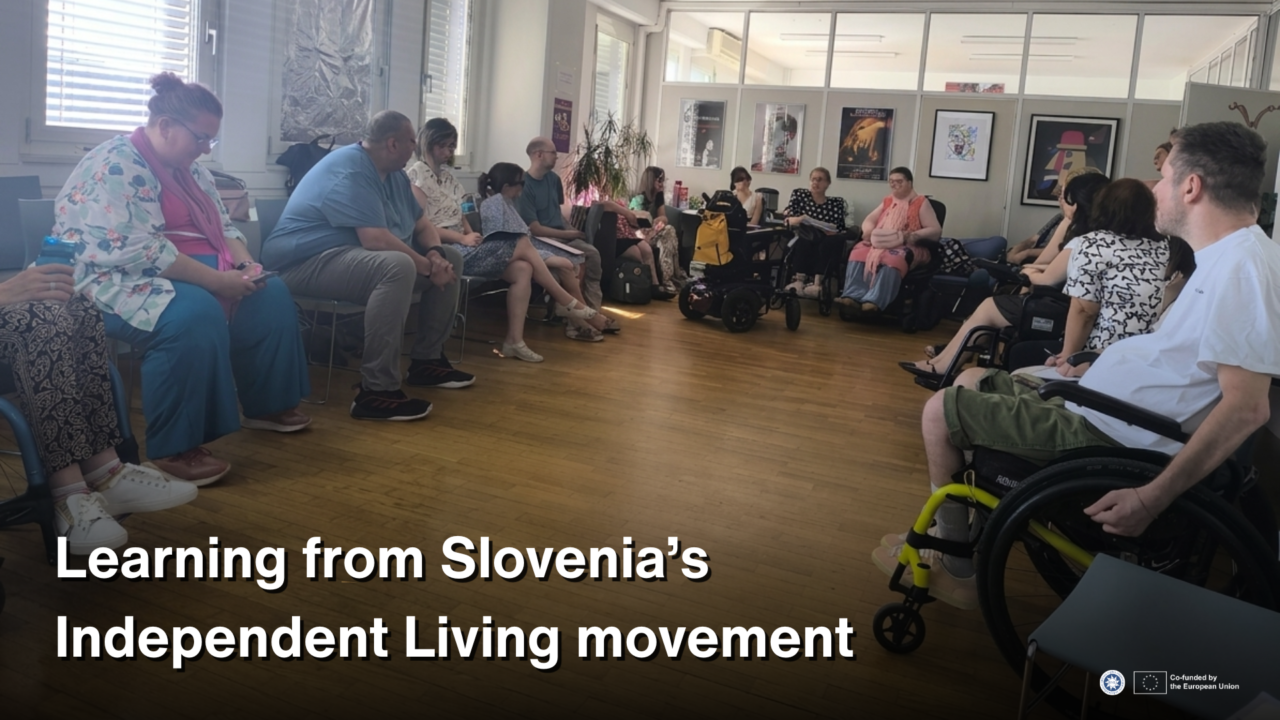 A group of people, including several wheelchair users, sit in a circle during a study visit discussion in Slovenia. White text over the lower part of the image reads: “Learning from Slovenia’s Independent Living movement.”