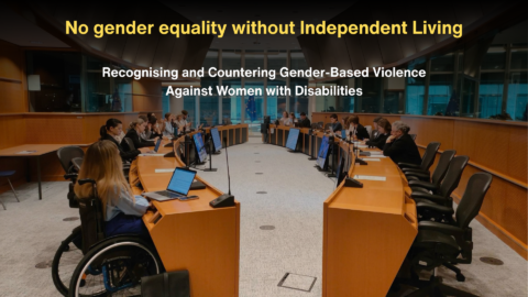Alt text: Photo of a European Parliament-style meeting room with participants seated around a large U-shaped conference table. A wheelchair user is visible in the foreground. Overlaid text reads: “No gender equality without Independent Living” and “Recognising and Countering Gender-Based Violence Against Women with Disabilities.”