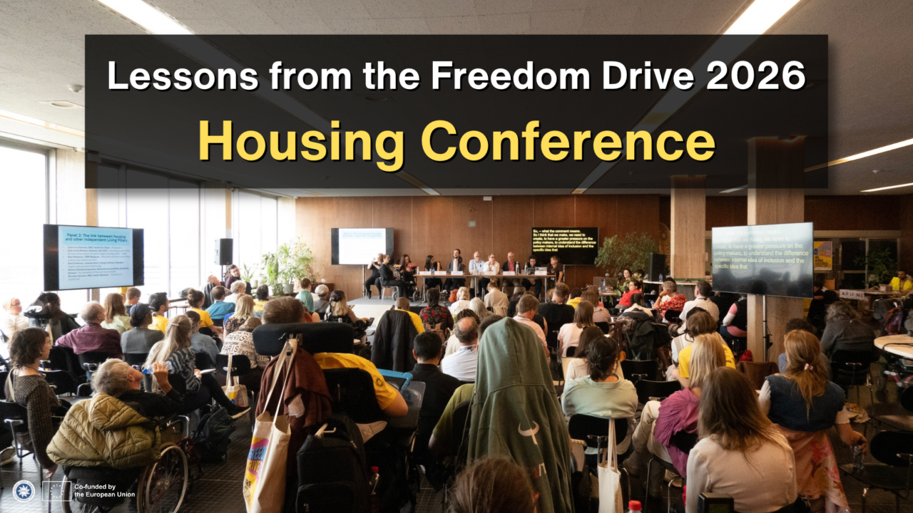 Graphic reading “Lessons from the Freedom Drive 2026 Housing Conference” over a photograph of a crowded conference room. Attendees, including wheelchair users, face a panel of speakers, with screens displaying presentation information and live captions. ENIL and European Union co-funding logos appear at the bottom left.